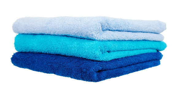 Blue cotton towels isolated on white.