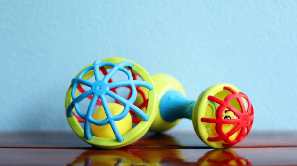 istock Baby rattles colorful attractive kids to play, multicolor bell using for improve learning and listening skill of baby put on a wooden table, isolated in blue wall background, education toys concept. 1287569959