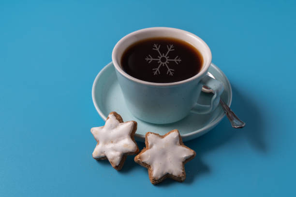 istock Cup of black coffee on blue background, with cookies, copy space for text. 1287571516