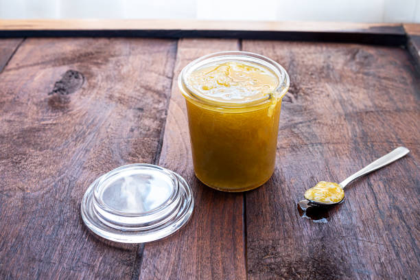 istock An glass jar and a spoon with jam 1287572410