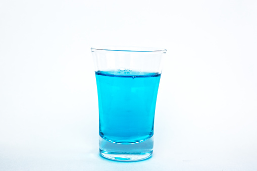 Small glass with blue water
