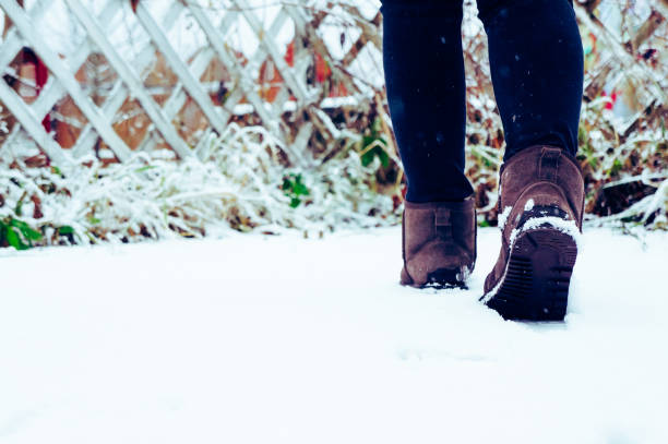 istock girl walks in the snow in boots 1287574021