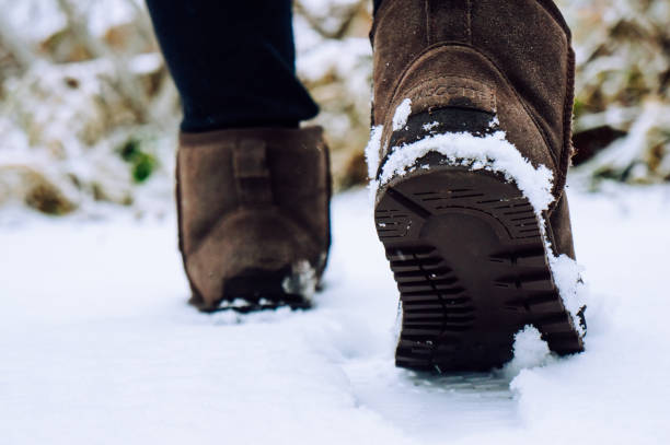 istock girl walks in the snow in boots 1287574023