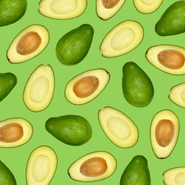 istock Pattern of fresh avocados over green 1287575077