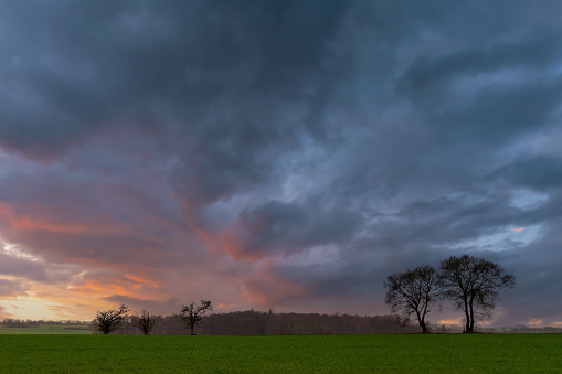 The sun setting over the Danish landscape in Saksild, Odder, Denmark.