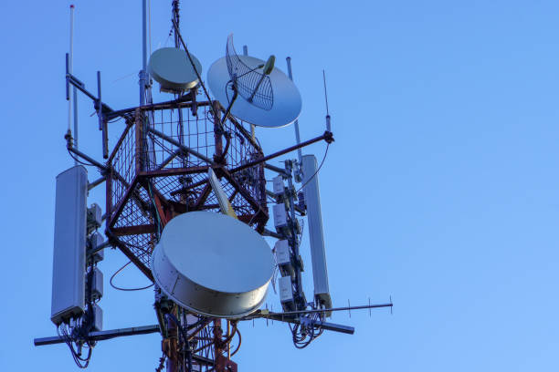 istock Telecommunications tower with 4G, 5G transmitters. cellular base station with transmitting antennas on a telecommunications tower against the blue sky. 1287576227