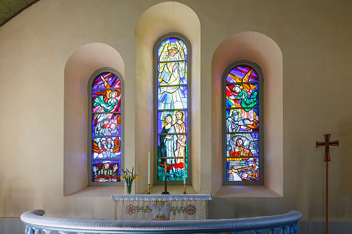 Interior of a church with stained glass and altar