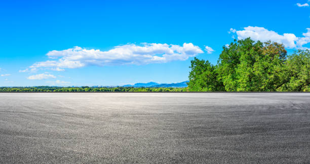 istock Empty road and green forest with mountain landscape. 1287576703