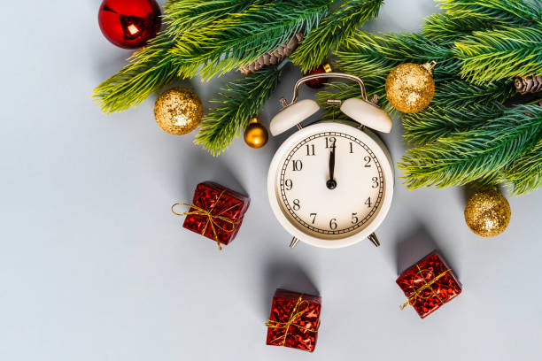 istock Christmas composition with an alarm clock and beautiful decorations on a blue background 1287577725