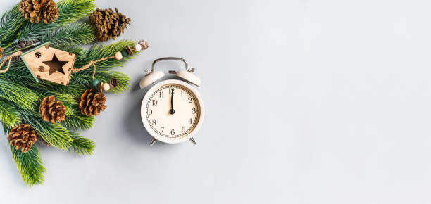 istock Christmas composition with an alarm clock and beautiful decorations on a blue background 1287577956