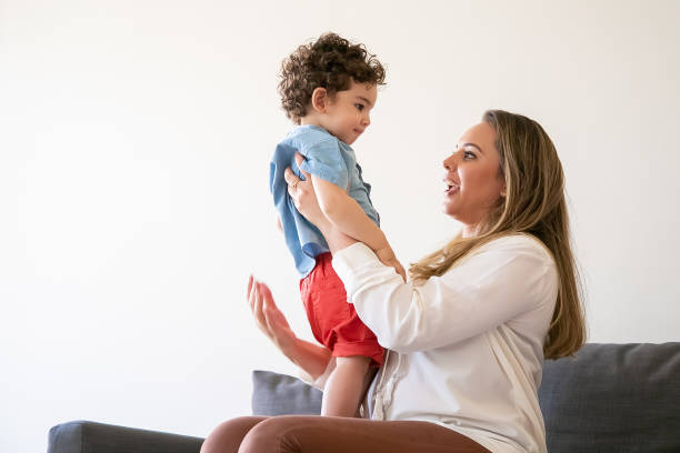 istock Long-haired mother holding little boy, talking with son 1287579444