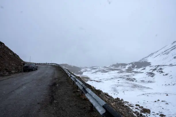 Dangerous road in the mountains. High Mountain Pass. Bad weather.