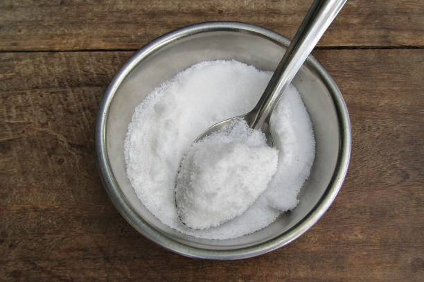 istock White Salt in a bowl with wooden background top view 1287580108