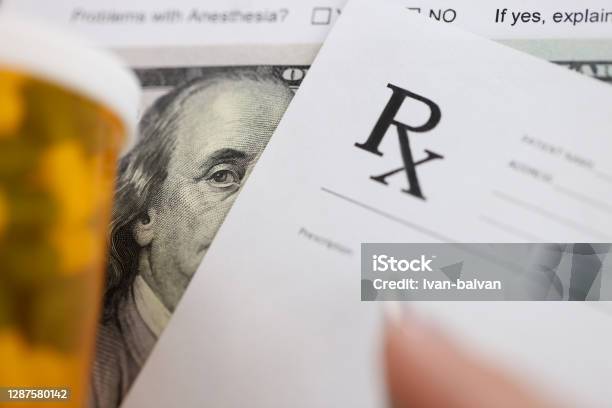 Dollar Bill And Doctors Prescription Are On Doctors Table In Clinic Closeup Stock Photo - Download Image Now