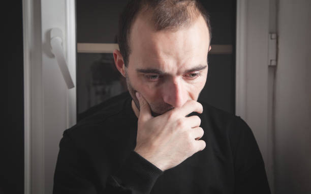 istock Caucasian sad and depressed man at home. 1287580926