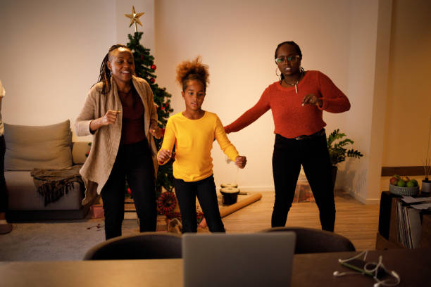 Tap tok Three female members of an African American family have lots of fun dancing Tik Tok routines on Christmas day. moving image stock pictures, royalty-free photos & images