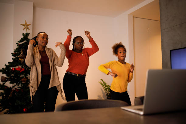 Tap tok Three female members of an African American family have lots of fun dancing Tik Tok routines on Christmas day. moving image stock pictures, royalty-free photos & images