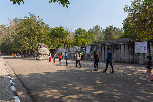CHANDIGARH, INDIA - November 20, 2020: Visitors with face masks ON following the social distance guidelines; enter the famous Rock Garden of Chandigarh, Mr. Nek Chand established the garden in 1957.