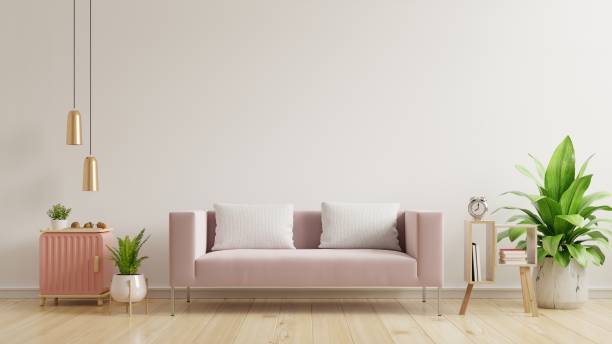 istock Interior wall mockup with empty white wall,pink sofa on wooden flooring. 1287581628