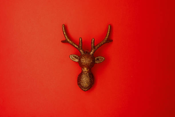 istock flat lay with christmas reindeer on red background 1287582440