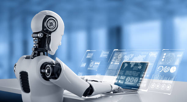 Robot humanoid use laptop and sit at table for big data analytic stock photo