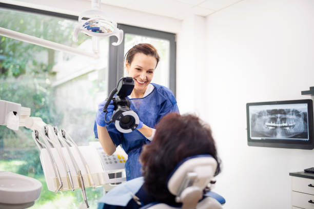 Dentist photographic teeth on patient.