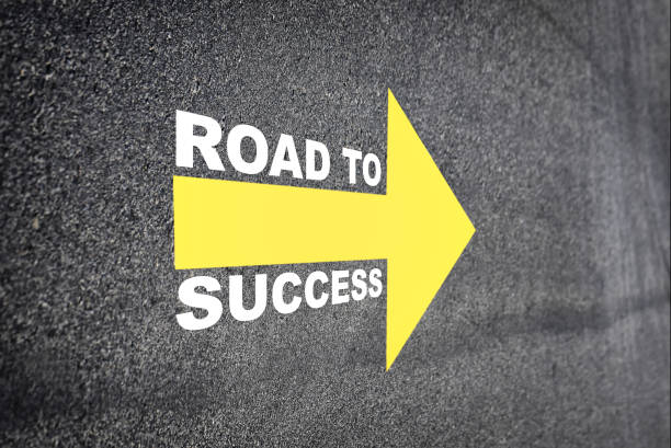 istock Road to success with yellow arrow marking on road surface 1287585831