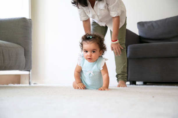 istock Cute funny baby crawling on floor at home 1287585878