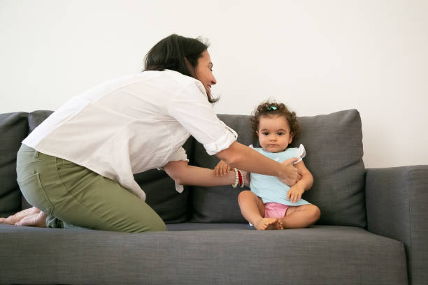 istock Happy black haired mother enjoying time with baby 1287587612