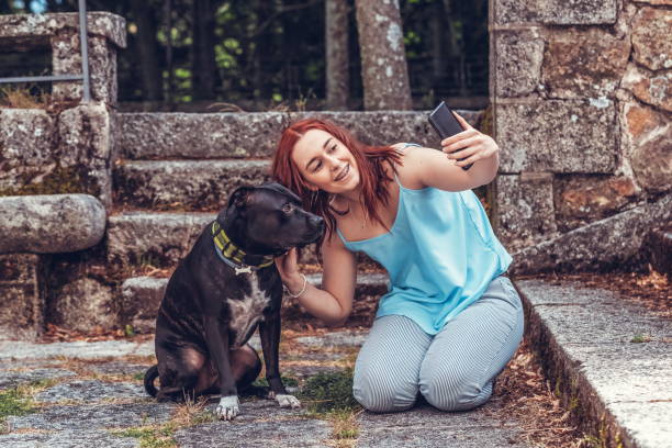 istock irl taking a selfie with her Pitbull dog 1287591674