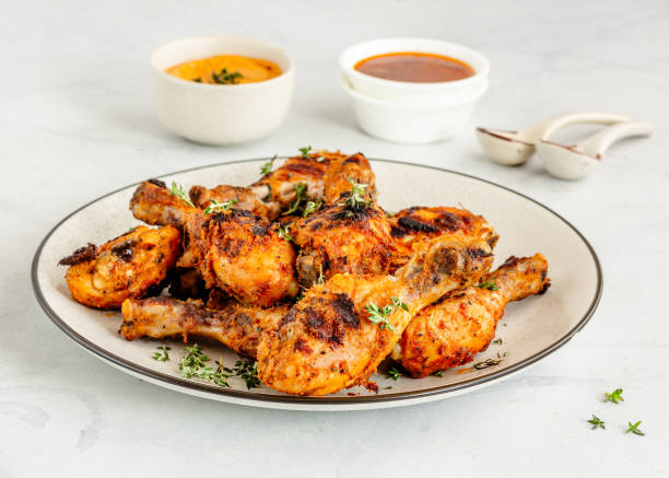 istock Griiled Chicken Drumsticks Garnished with Fresh Thyme and Other Condiments 1287592557