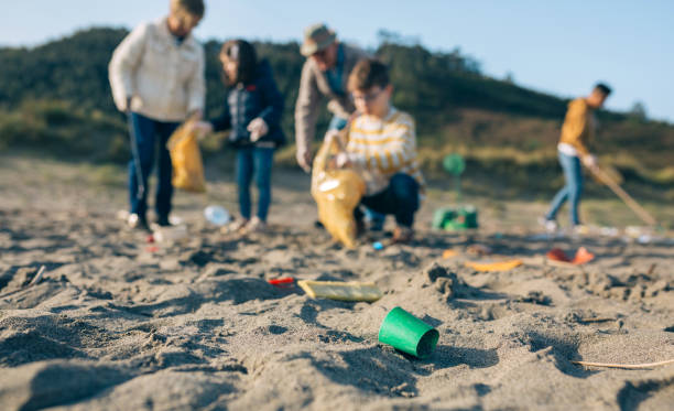 istock Volunteers cleaning the beach 1287593516