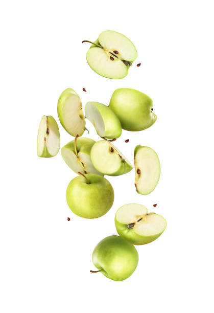 istock Cut green apples in flight on a white background 1287593897