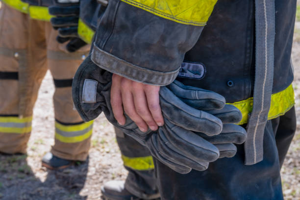 istock hands of firefighters with gloves on their hands 1287595582