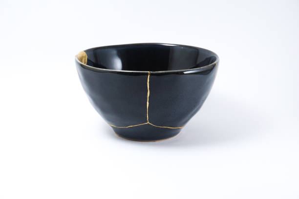 istock Kintsugi black bowl repaired with gold. 1287597032