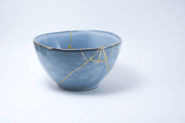 Kintsugi blue bowl repaired with gold. stock photo