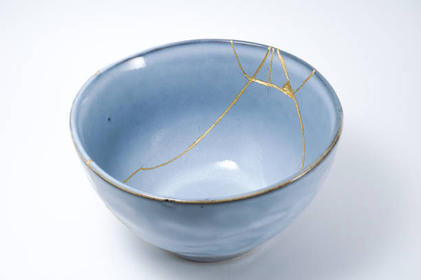 Kintsugi blue bowl repaired with gold. stock photo