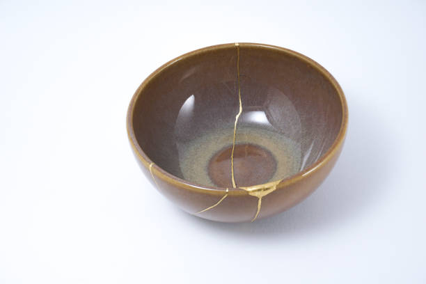 istock Kintsugi brown bowl repaired with gold. 1287597309