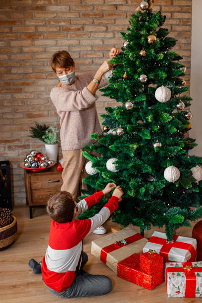 istock Grandma and grandson decorating Christmas tree. 1287597337