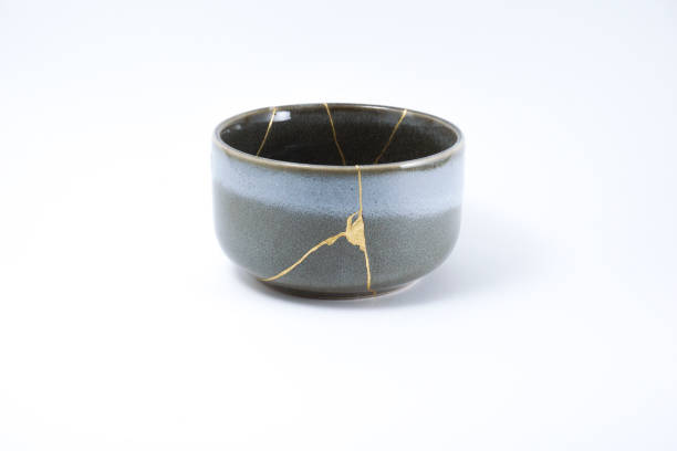istock Kintsugi grey bowl repaired with gold. 1287597343
