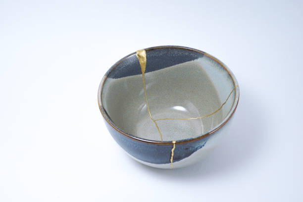 istock Kintsugi broken Japanese grey bowl repaired with gold. 1287597350