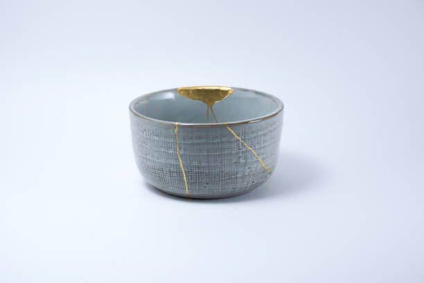 istock Kintsugi grey bowl repaired with gold. 1287597362