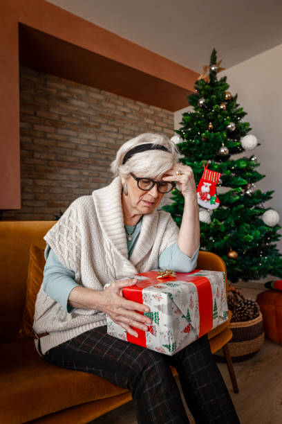 istock Depressed Elderly woman alone for Christmas. 1287597372