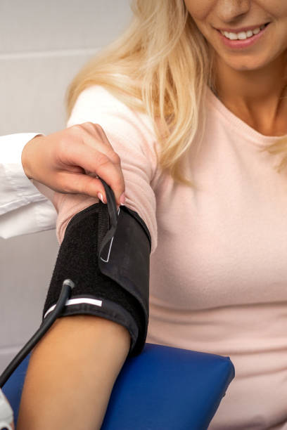 istock Doctor puts on tonometer on arm 1287598976