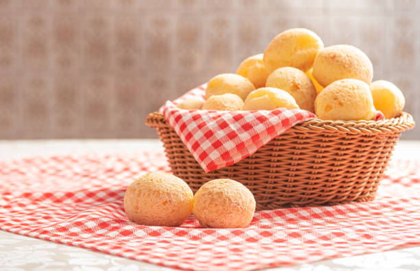 cheese bread from brazil. cheese bread on a table with red and white checked tablecloth, selective focus. - cooked bread food cup imagens e fotografias de stock