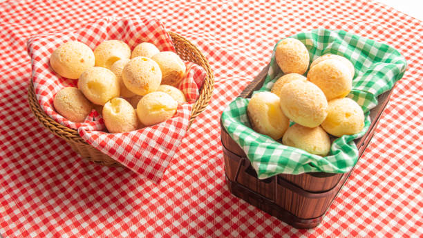 istock Cheese bread from Brazil. Cheese bread on a table with red and white checked tablecloth, selective focus. 1287600293