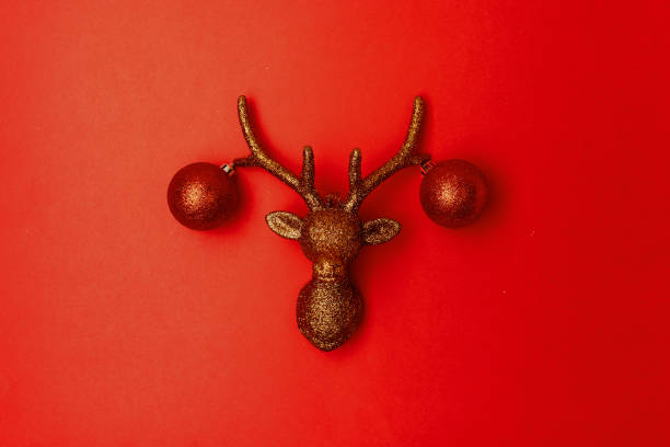 istock flat lay with christmas reindeer on red background 1287600338