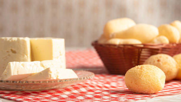 istock Cheese bread from Brazil, paes de queijo and minas cheese on an old white table with blurred nature in the background, natural light, selective focus. 1287600358