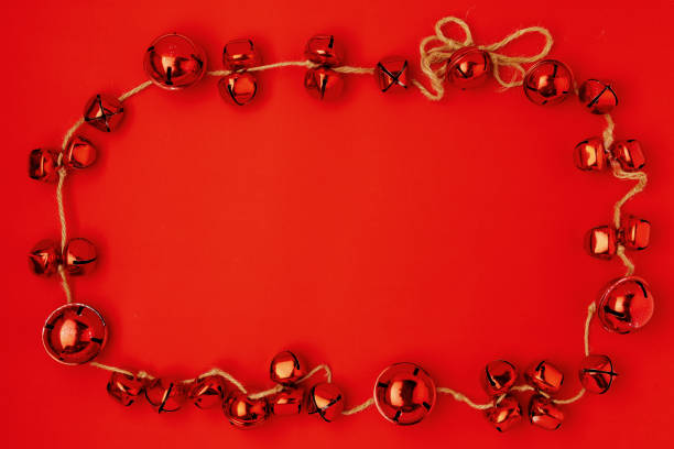 istock flat lay with christmas jingle bells on red background 1287600403