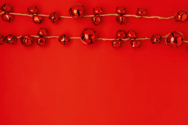 flat lay with christmas jingle bells on red background